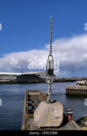 Modern public art work featuring a chain and hook recalls the work of cranes in the docks, Ayr,Scotland,UK Stock Photo