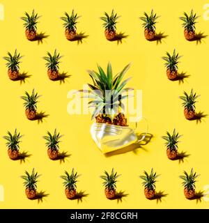 Many pineapples on a solid yellow background pattern Stock Photo