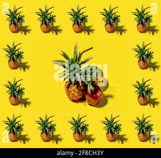 Many pineapples on a solid yellow background pattern Stock Photo