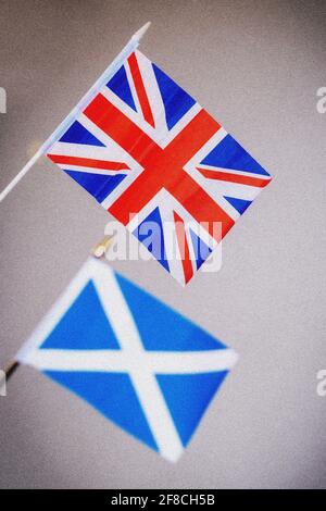 Flags of the United Kingdom (Union flag, above) and Scotland (Saltire or Saint Andrew's Cross, below) shot against a neutral background Stock Photo