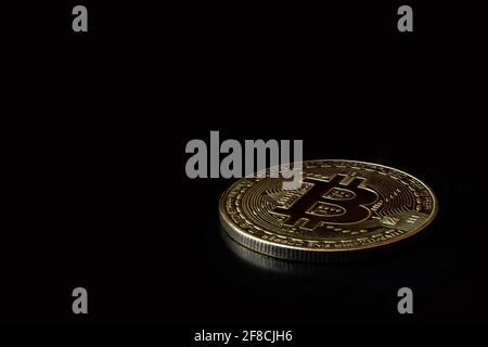 Close up one golden coin with bitcoin symbol on black background. Cryptocurrency, Money coins digital. Blockchain technology, bitcoin mining concept, Stock Photo