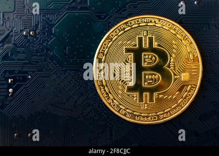 Golden coins with bitcoin symbol on blue mainboard circuit background. Cryptocurrency, Money coin digital. Blockchain technology, bitcoin mining. Stock Photo
