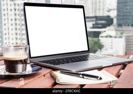 laptop, coffee and notepad for remote working in Bangkok Stock Photo