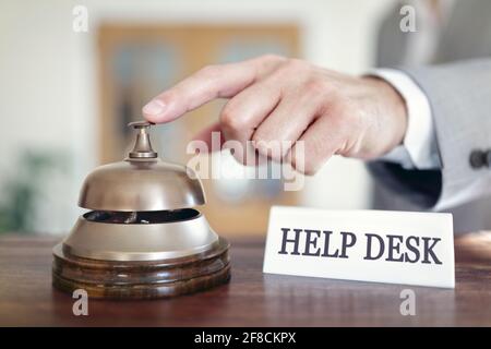 Businessman ringing a help desk assistance service bell Stock Photo