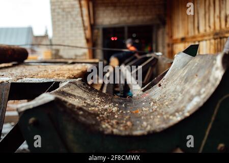 a log on a conveyor belt. transportation of wood raw materials at the plant. wood processing on a sawmill. automated conveyor Stock Photo