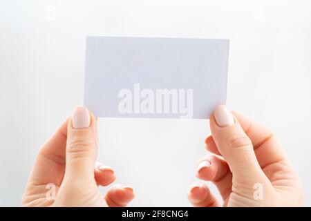 Hand holding empty white business card Stock Photo