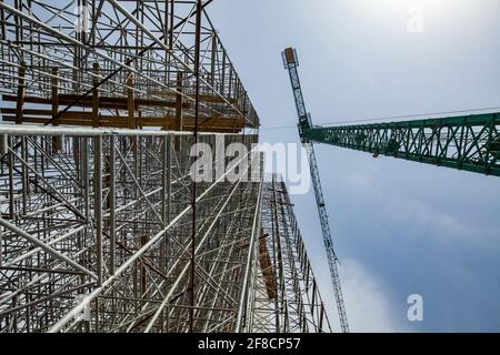 Construction of modern high-rise ski-jump in Shchuchinsk city, Kazakhstan. Tall crane and scaffoldings. Stock Photo