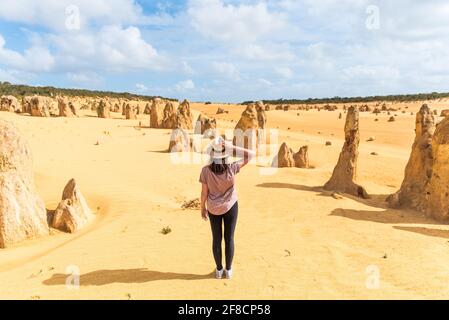 Girl tourist wearing hat and looking at  unique Pinnacles Desert in Nambung National Park in Western Australia. Concept of tourism, vacation travel an Stock Photo