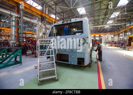 Kazakhstan, Nur-sultan. Locomotive-building plant. Workers assembling locomotive cabin. Stock Photo