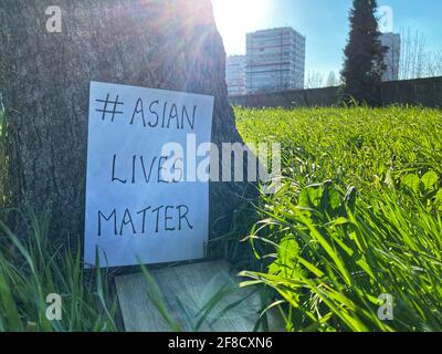 Asian Lives matter, says the sign at the bottom of a tree. Used to show solidarity to Asians across the globe suffering from racism. Stop Asian Hate m Stock Photo