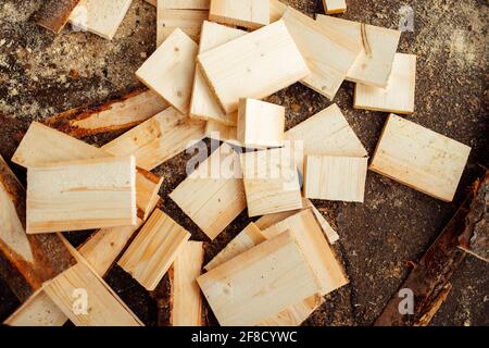 wooden board on the conveyor. people work on an automated sawmill. industrial enterprise for wood processing. a worker carries a board for sawing Stock Photo
