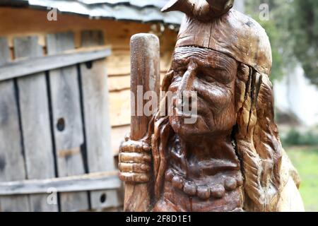 View of wooden sculpture of Baba Yaga in Gurzuf Park in spring Stock Photo