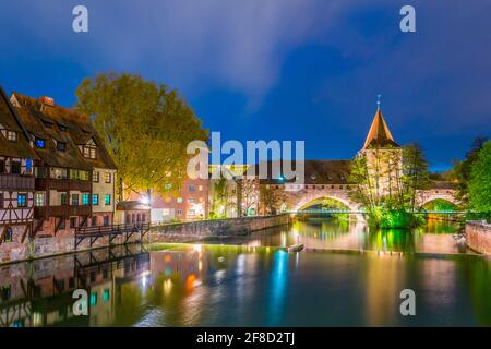 Night view of historical old town with view of Weinstadel, bridge and Henkerturm tower in Nurnberg, Germany. Stock Photo