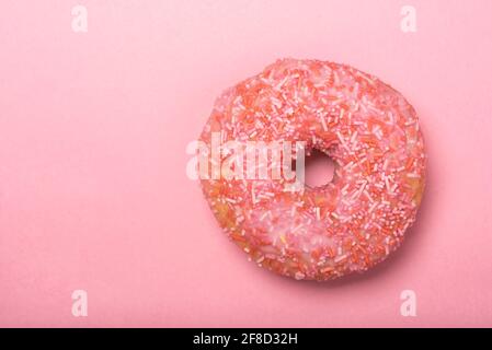 Colourful iced ring doughnuts with sprinkles. Stock Photo