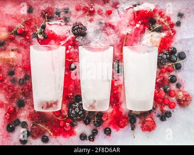 Glasses and frozen berries. Closeup, view from above. Tasty and healthy eating concept Stock Photo