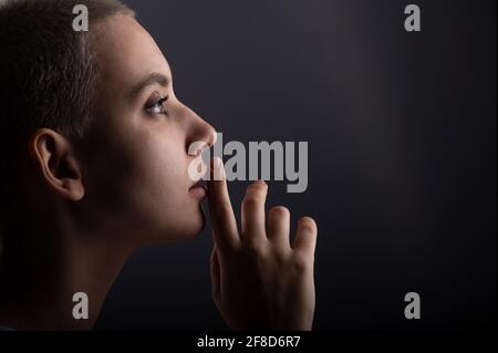 Portrait of pensive young woman with short hair on white background. Copy space Stock Photo