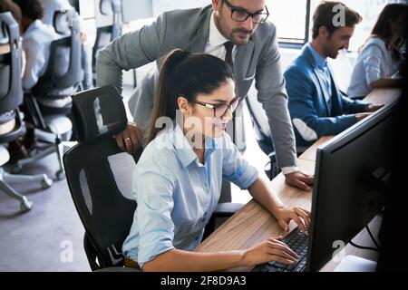 Programmers cooperating at IT company developing apps Stock Photo