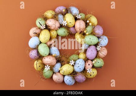 Motley easter eggs on brown background. Stock Photo