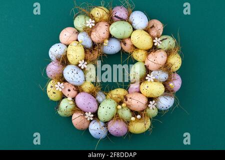 Colored easter eggs on dark green background. Stock Photo