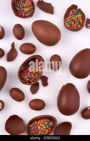 Vertical shot of choco eggs with rainbow sprinkles filling. Stock Photo