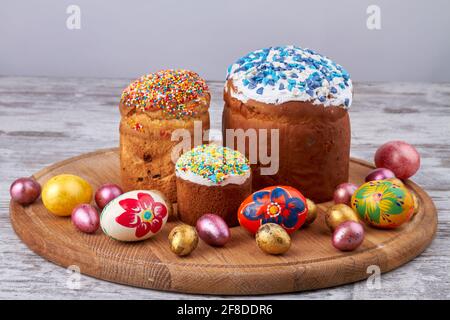 Still life easter cakes and eggs on wooden board. Stock Photo