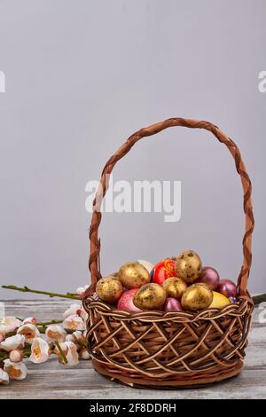 Basket of decoratied easter eggs and flowers. Stock Photo