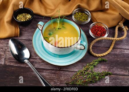 Fresh fish soup with ingredients and spices for cooking. Wooden background. Top view Stock Photo