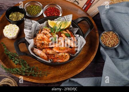 Boiled shrimp on a plate on a wooden table Stock Photo