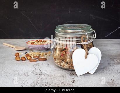 Home made granola with dried fruits and nuts in a mason jar Stock Photo