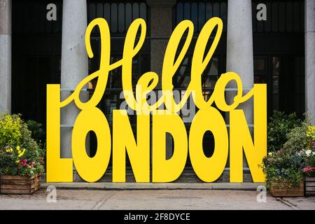 London, UK. 13 April 2021. A yellow Hello London sign welcomes people to Covent Garden. Credit: Waldemar Sikora Stock Photo