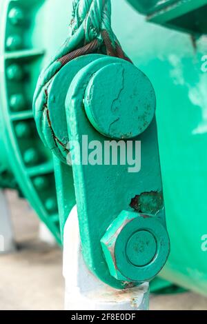 Close up view of of an old green steel shackle with a large nut and rusty steel cable Stock Photo