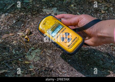 PRIPYAT, UKRAINE, AUGUST 30, 2019: Male hand holding a geiger counter at Chernobyl Exclusion zone in the Ukraine Stock Photo