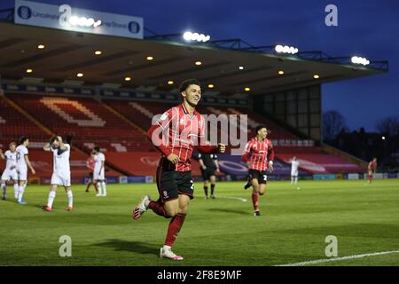 LINCOLN, UK. APRIL 13TH: Brennan Johnson of Lincoln City celebrates his ...