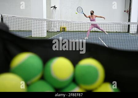 Pingpong and tennis balls located on the white background Stock Photo