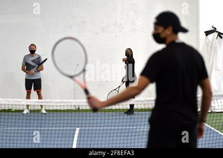 Philip Hinder participates in a tennis class at the Tennis Innovator