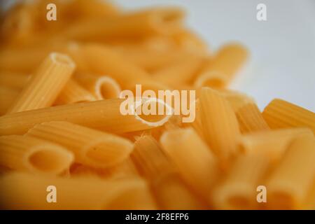 Raw macaroni on white. Dry noodles. Uncooked pasta. Stock Photo