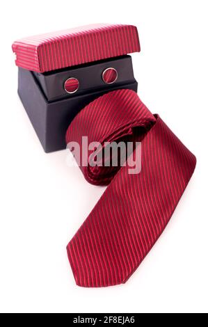Red silk business tie rolled up over white background. Stock Photo