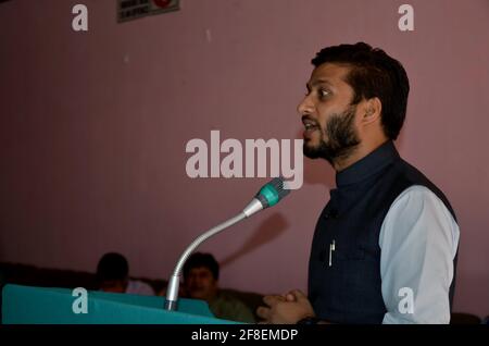 Man asian is giving lecture in a public hall during a function Stock Photo