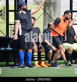 New Delhi, India - July 19 2019: Footballers of local football team during game in regional Derby championship on a bad football pitch. Hot moment of Stock Photo