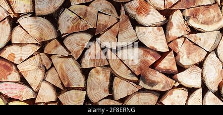 Background texture from chopped quarters of firewood stacked together Stock Photo