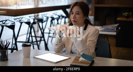 Fashion asian woman designer using digital tablet. Stock Photo