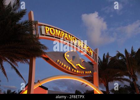 Sign of the Pompano Beach Fisher Family Pier at sunset. Pompano Beach, Florida Stock Photo