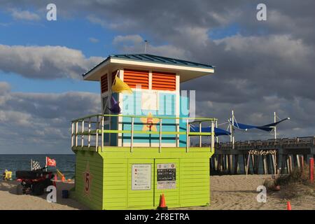 Colorful Lifeguard tower near Pompano Beach Fisher Family Pier during an overcast day. Stock Photo