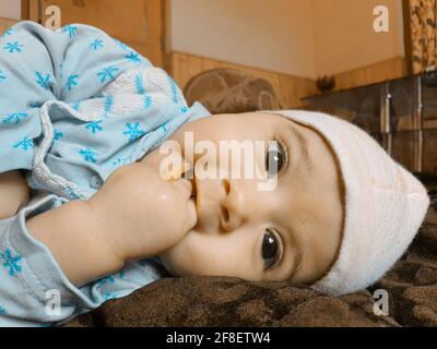 Smiling kid photographs at home under blanket looks beautiful. Digital and 4k photos of child. Stock Photo