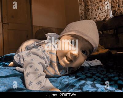 Smiling kid photographs at home under blanket looks beautiful. Digital and 4k photos of child. Stock Photo