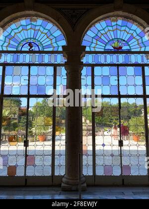 Inside the The Vizcaya Museum and Gardens in Miami Florida. Beautiful tea room with colorful stained glass windows reflecting a rainbow of light Stock Photo