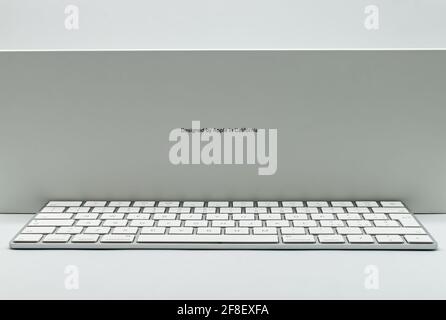 New iMac 21,5 inch keyboard personal computer made by Apple Computers, isolated on white background. Side view Stock Photo