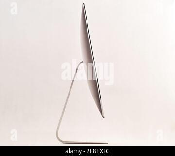 New iMac 21,5 inch personal computer made by Apple Computers, isolated on white background. Side view Stock Photo