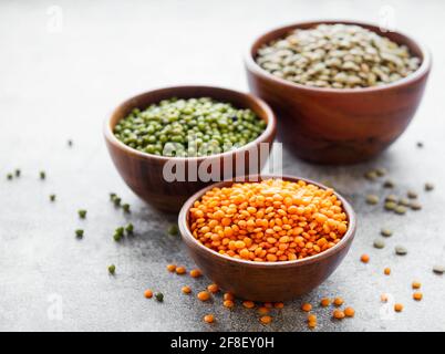 Bowls with different types of legumes on a gray concrete background Stock Photo