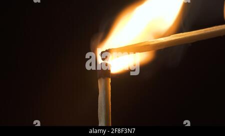 Photo of wood thin burning stick on black Stock Photo